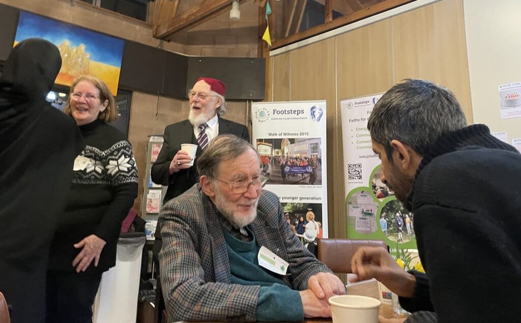 Footsteps iftar with John Nightingale seated centre talking to Toqueer Quyyam and Peter Rookes standing behind