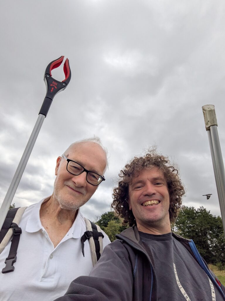 Litterpicking at Balsall Heath Park to start our procession, with Peter, creator of the Retrofit Balsall Heath mobile model home.